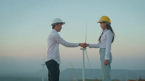 People engineer areshaking hand in a field  wearing a protective helmet on he Stock Footage 149048699