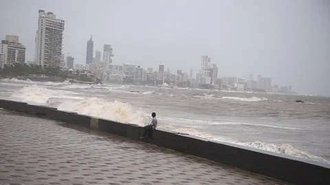 People enjoy high tidal waves at Worli Seaface Stock Footage 76994593