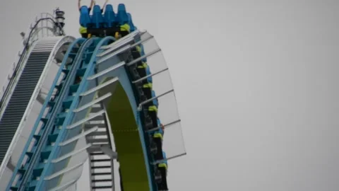 People Enjoy Steep Drop on Rollercoaster at Amusement Park Video stock 332381096
