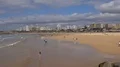 People enjoy sunny beach and ocean at Portimao skyline Portugal 4k or 4k+ Resolution