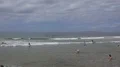 People enjoy sunny day at the ocean 4k or 4k+ Resolution