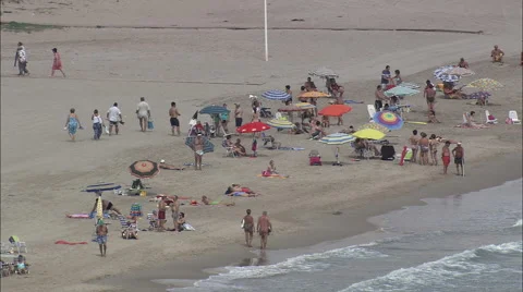 People enjoying day at the beach Stock Footage 66825668