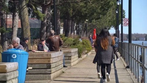 People Enjoying Spring TIme Walking Along The Boardwalk Stock Footage 75321074