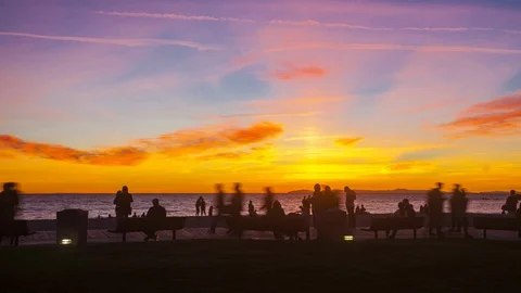 People Enjoying Sunset On The Beach Stock Footage 101686055