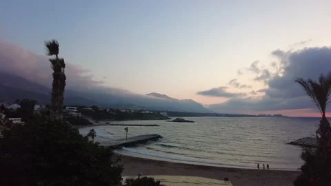 People enjoying the sunset despite the wind and waves Video stock 219814981