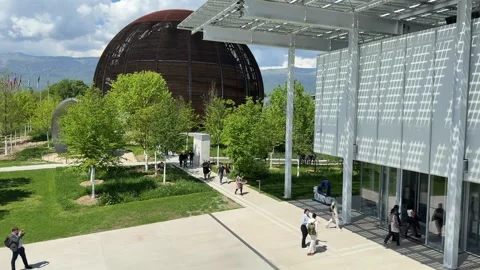 People Entering The Main Building Of CERN Headquarters In Switzerland. Globe Of Stock Footage 321674086