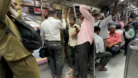 People Entering Packed Local Train Coach at Busy Indian Station Stock Footage 347024142