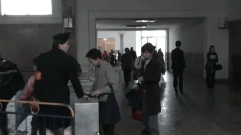 People entering the ticket control machine in subway, Pyongyang, North Korea Stock Footage 260480812