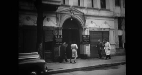People entering U.S. Information Agency office Stock Footage