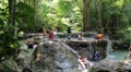 People in Erawan National Park and Erawan Waterfall in western Thailand HD Footage