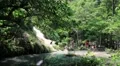 People in Erawan National Park and Erawan Waterfall in western Thailand HD Footage