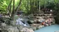 People in Erawan National Park and Erawan Waterfall in western Thailand HD Footage