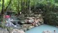 People in Erawan National Park and Erawan Waterfall in western Thailand HD Footage