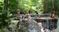 People in Erawan National Park and Erawan Waterfall in western Thailand HD Footage