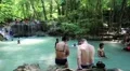 People in Erawan National Park and Erawan Waterfall in western Thailand HD Footage