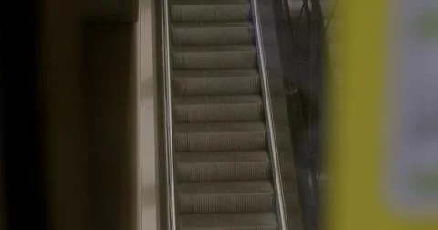People on the escalator going down. escalator going down Stock Photos