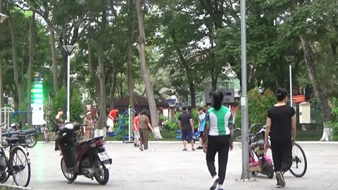 People exercise and play hacky sack in the park Stock Footage 333105908