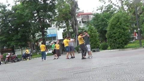 People exercise and play hacky sack in the park Stock Footage 333105977