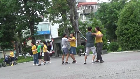 People exercise and play hacky sack in the park Stock Footage 333105991