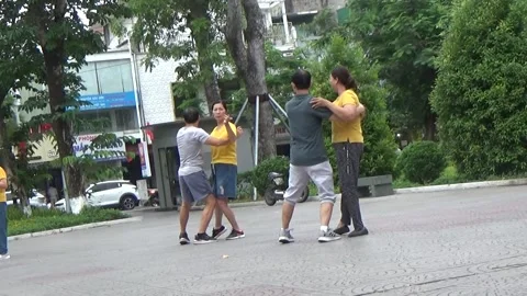 People exercise and play hacky sack in the park Stock Footage 333106035
