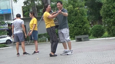 People exercise and play hacky sack in the park Stock Footage 333106080