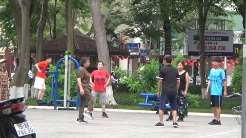 People exercise and play hacky sack in the park Stock Footage 333106114