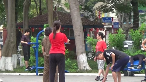 People exercise and play hacky sack in the park Stock Footage 333107027