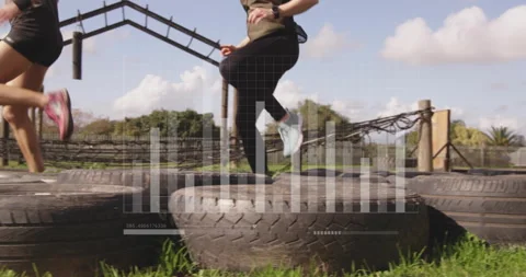People exercising on large tires with data processing animation overlay Stock Footage 303676335