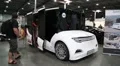 People at exhibition of electric cars. White electromobile HD Footage