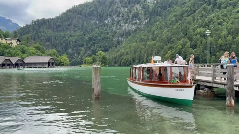 People exit boat, ferry which just arrived at Konigssee town. Bavaria, Germany Stock Footage 333584164