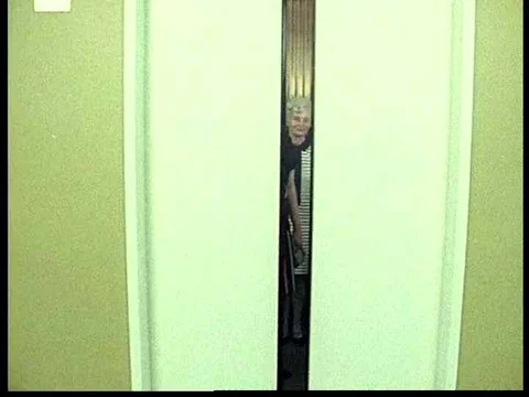 People exit an elevator leaving two women aboard, and a woman makes a deposit Stock Footage 75763576