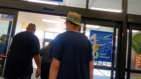 People exiting Walmart in groups Stock Footage 144005482
