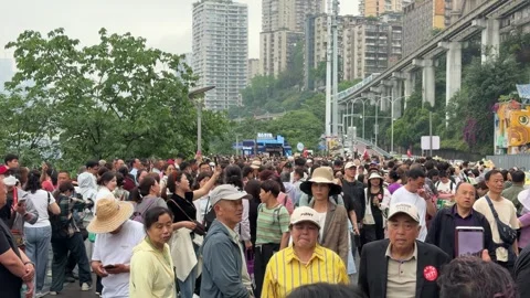People explore, taking videos and photos of the iconic monorail outside Liziba Stock Footage 336493179