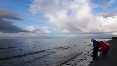 People exploring beach with sky background, enjoying outdoor adventure together Stock Footage 279063128