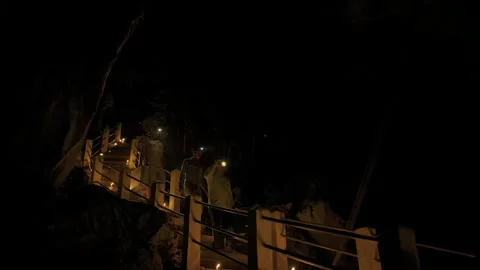 People exploring a dark cave with headlamps Stock Footage 331952835