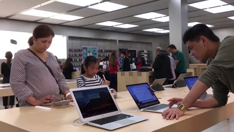 People Exploring New Computers and Electronics at a Modern Retail Store Showroom Stock Footage 328219570