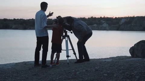 People exploring stars on shore of lake Stock Footage