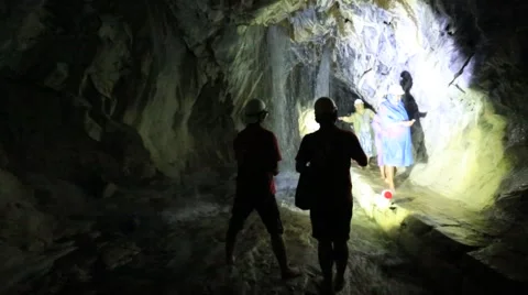 People exploring the waterfall in a deep cave Stock Footage 51633763