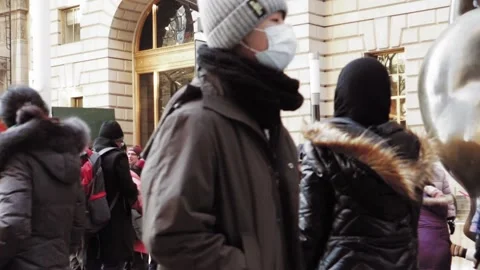 People with face masks in agglomeration walking at the street Stock Footage 136207645