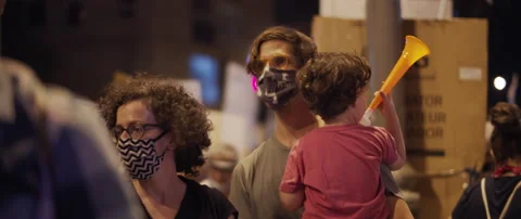 People in face masks attending a protest Stock Footage 152848514