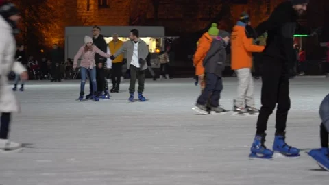 People Fall While Ice Skating at Budapest Exterior Ice Rink At Night Stock Footage 225876870