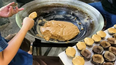 People filling tiny muffin forms with coconut sugar. Video stock 205544590
