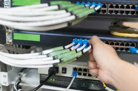 People fix core switch in network room Stock Photos