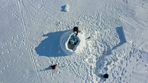 People fix ice block on white igloo construction in winter Video stock 131797932