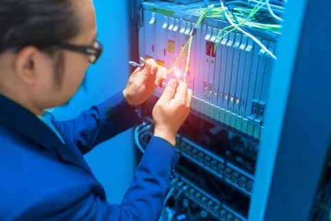 People fix node fiber optic in network room Stock Photos
