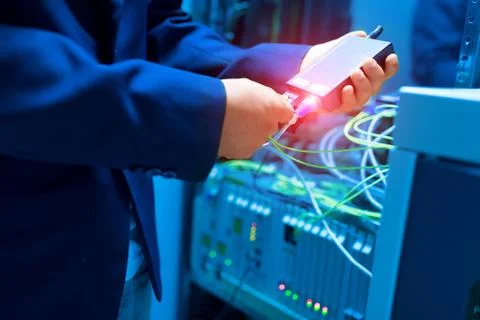 People fix node fiber optic in network room Stock Photos