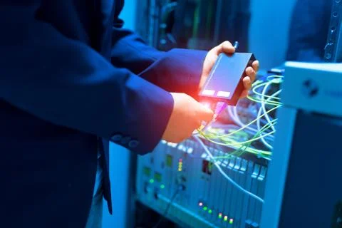 People fix node fiber optic in network room Stock Photos