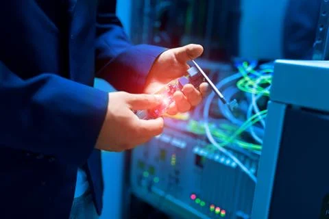 People fix node fiber optic in network room Stock Photos