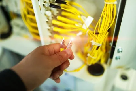 People fix node fiber optic in network room Stock Photos