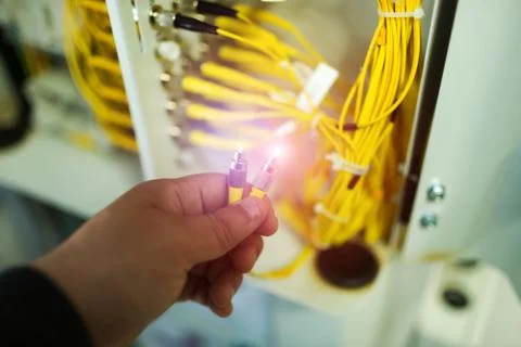 People fix node fiber optic in network room Stock Photos